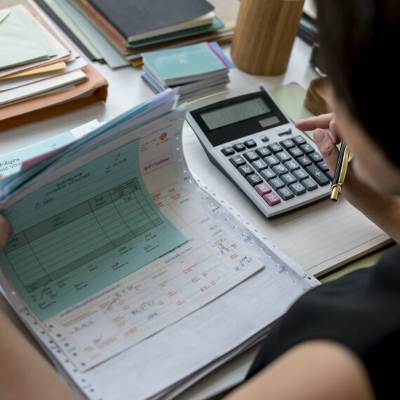 Adult asian woman working on payment bills accounting summary data