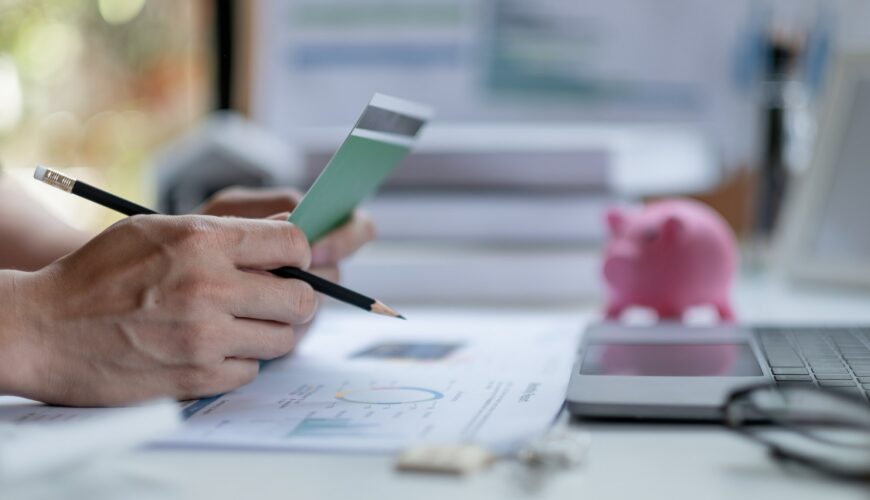 Business man hands holding saving account passbook with calculator, account and saving concept