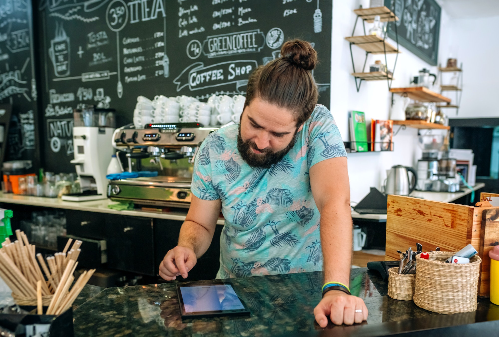 Coffee shop owner reviewing business accounts Coffee shop owner reviewing business accounts