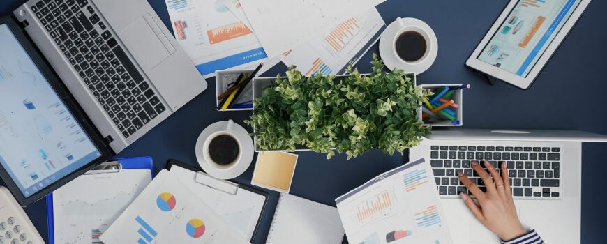 Top view of businesswoman typing financial accounting expertise on laptop