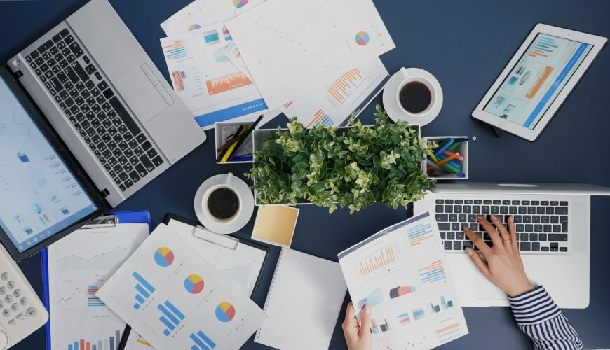 Top view of businesswoman typing financial accounting expertise on laptop